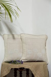 White Eri Cushion With Basket Weave Border And Knotted Design